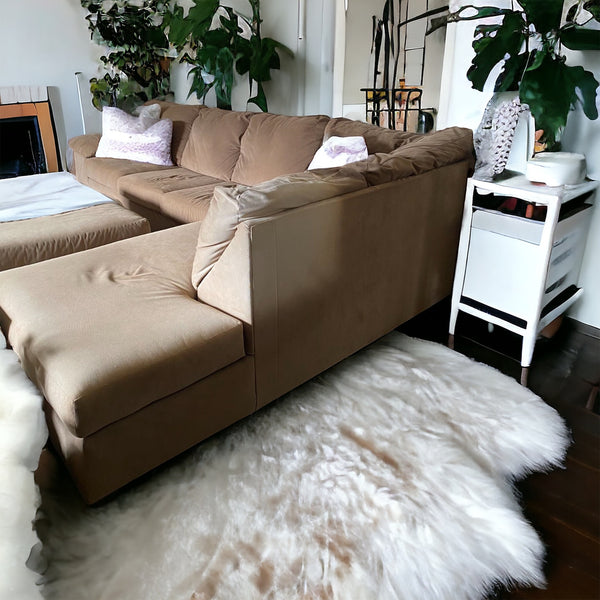 Tan colored sectional with ottoman